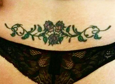 Rose vine low back tattoo Rose Lower Back Tattoo, Traditional Lower Back Tattoo, Vine Tramp Stamp, Rose Tramp Stamp, Thigh Rose Tattoo, Low Belly Tattoo, Cute Belly Tattoos, Low Stomach Tattoo, Low Back Tattoo