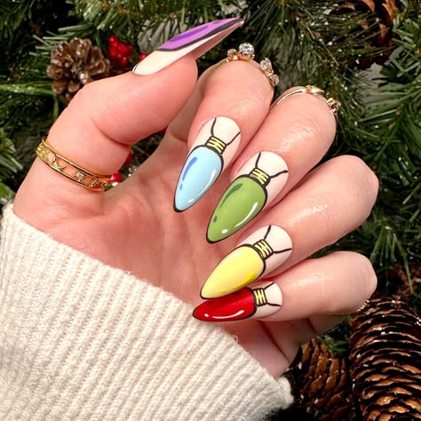 Dawn Witch Designs Unique, re-usable, hand painted, and made in Canada. These luxury press on nails are handmade using high quality gel polish and salon-grade materials.  ✨ STRANDS OF COMIC LIGHTS ✨  This playful set features hand-painted Christmas bulbs done in cartoon style, topped with a matte top coat to really enhance the 2D-comic effect. Due to the shape of lightbulbs, this set looks best on almond or stiletto shaped nails.  *The shape shown in the pictures is the MEDIUM STILETTO *Colours may appear a little different due to your personal monitor settings* ✨ BUY 3 GET 1 PROMOTION ✨  ➜ Buy 3 sets of press on nails and get a free solid set!  ➜ How: Purchase 3 sets of nails, and then message me with the following information for your free solid set:  1: colour (choose any solid colour f Pop Art Christmas Nails, Christmas Light Nail Designs, Light Bulb Nails, Christmas Lights Nail Art, Gel Nail Christmas, Dope Christmas Nails, Nails Christmas Lights, Elf Nail Art, Christmas Light Nail Art