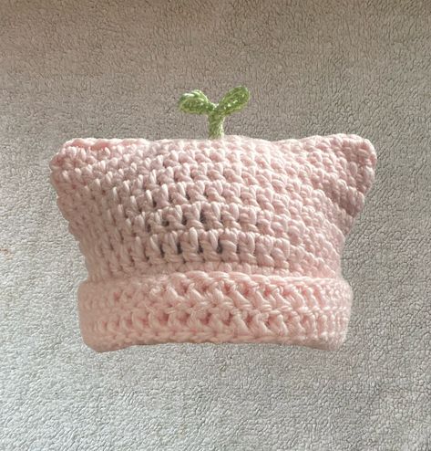 The Pink Sprout Plant Cat Beanie is meant for those who want to add something unique yet adorable to your wardrobe but also convenient for the fast approaching colder months. The plant is made of a cotton and acrylic blend of yarn (60% cotton, 40% acrylic) and the pink beanie part is made up of alpaca and acrylic blend yarn (80% acrylic, 20% alpaca wool), handmade crotched by me. PLEASE READ IN REGARDS TO MATERIALS: Because the pink base of the beanie is made of alpaca wool, there are hairs that Cat Crochet Beanie, Pink Cat Hat, Crochet Cat Beanie, Pink Beanie, Cat Beanie, Crochet Business, Crochet Design Pattern, Kawaii Crochet, Beginner Crochet Projects