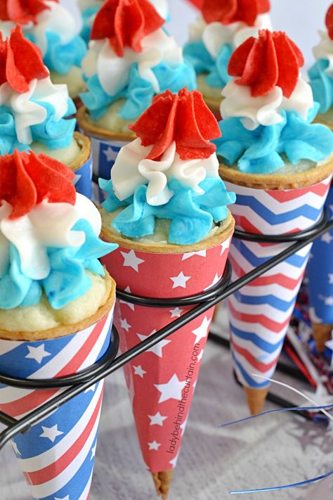 Start out the summer right with these adorable Bomb Pop Ice Cream Cone Cupcakes. Perfect for a pool party, 4th of July or Memorial Day. These cupcakes are Bomb Pops, Cone Wrappers, Cupcake Ice Cream Cones, Cherry Frosting, Blue Raspberry Lemonade, Patriotic Treats, Cone Cupcakes, Ice Cream Cone Cupcakes, Pop Ice