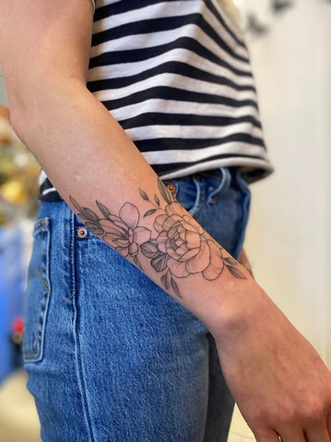 Top Of Wrist Flower Tattoo, Magnolia Tattoo Wrist, Peony Tattoo On Forearm, Peonies Tattoo Wrist, Small Peony Wrist Tattoo, Peony Wrap Around Tattoo, Magnolia Wrist Tattoo, Peony Forearm Tattoo Women, Forearm Peony Tattoo