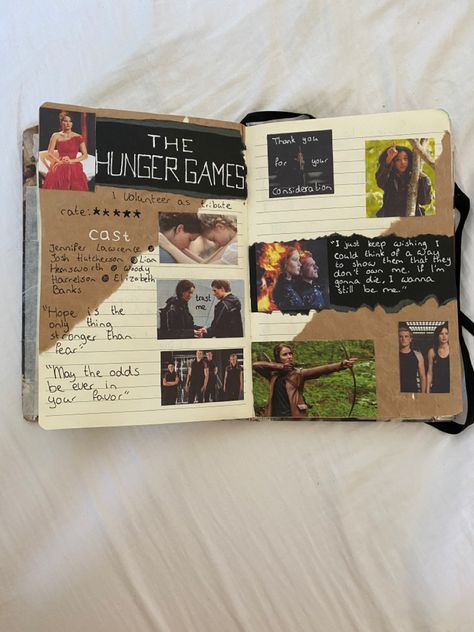 This is my journal where I made a hunger games page in based on the movies. I wrote down quotes and the cast. I also used photos from scenes in the film and brown and black paper. Hunger Games Scrapbook Ideas, The Hunger Games Journal Page, Movie Journal Cover, Hunger Games Scrapbook, Netflix Journal, Fan Journal, Volunteer As Tribute, Book Review Journal, Movie Journal