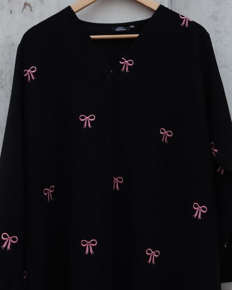 Introducing our Black Abaya with Pink Bow Embroidery! 🎀✨ This abaya effortlessly combines timeless elegance with a touch of modern flair. Made from luxurious black fabric, it’s elevated by the adorable pink bow embroidery. 🌸 Perfect for both casual outings and special occasions, this trendy piece is designed to stand out while keeping you comfortable. Meticulously crafted to ensure quality and style in every stitch. Step up your modest fashion game with Malikah. 💫 #malikahmodestwear #bowa... Embroidery Abaya, Bow Embroidery, Black Abaya, Pink Bow, Black Fabric, Modest Fashion, Step Up, Fashion Games, Timeless Elegance