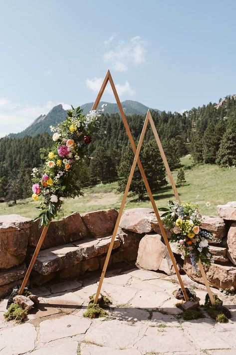 Mountain Wedding Ceremony Arch | Halfway House Wedding in Boulder, CO | A breathtaking wedding arch set against a stunning Colorado mountain wedding backdrop. The geometric wooden structure is adorned with vibrant colorful wedding floral arrangements. Book Nina for your Colorado wedding or adventure elopement at larsenphoto.co! Mountain Wedding Ceremony, Ceremony Arches, Wedding Floral Arrangements, Halfway House, Colorado Mountain Wedding, Wedding Ceremony Arch, Mountain Wedding Colorado, Breathtaking Wedding, Boulder Co