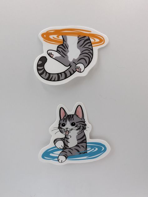 This item includes both stickers (top and bottom halves) of this cute portal cat. In the spirit of the popular game, this cat transverses the inter-spatial portals between planes. Each sticker measures approximately 2 x 2 inches (the 'head' cat is 2.2 x 2, and the 'tail' cat is 2 x 1.6). I have drawn the designs myself, but they are printed by stickermule.com to ensure a high-quality product. Game Stickers, Stickers Ideas, Cute Cat Stickers, Popular Stickers, Creative Stickers, Stickers To Print, Sticker Designs, Art Drawings Sketches Pencil, Tattoo Stickers