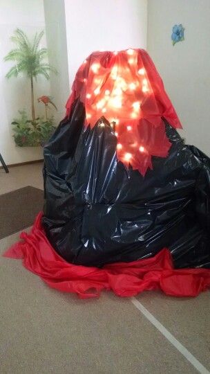 I used a stepladder, two folding chairs, black trashbags, a string of lights, a red plastic tablecloth, and some dry ice to make this awesome volcano! Easy peasy, lemon squeezy! The Floor Is Lava Trunk Or Treat, Volcano Birthday Party Decorations, Floor Is Lava Trunk Or Treat, Moana Trunk Or Treat Ideas, Diy Volcano Decoration, Floor Is Lava Decorations, The Floor Is Lava Birthday Party, Diy Large Volcano Prop, Dinosaur Volcano Birthday Party