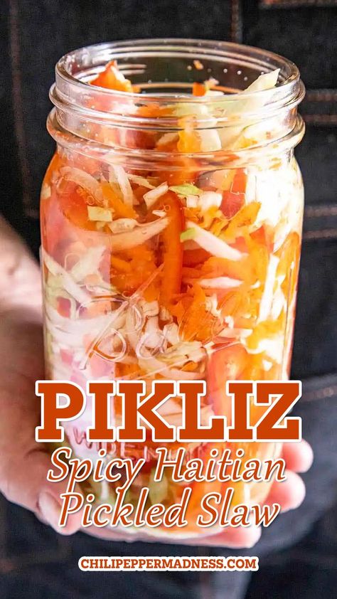 Holding a jar of the Pikliz (Spicy Haitian Pickled Slaw). Pepper Brine Recipe, Pikliz Recipe, Haitian Pikliz, Pickled Slaw, Carrot Slaw, Shredded Cabbage, Spicy Chicken Recipes, Fermented Cabbage, Pickled Cabbage