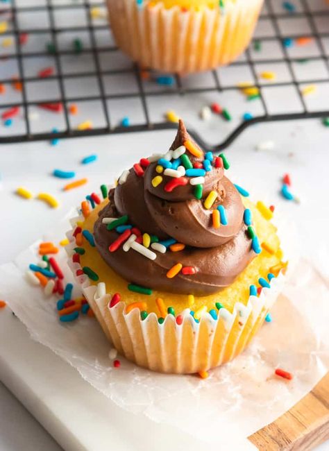 Take your boxed cake mix cupcakes to the next level with a few simple additions. These Easy Vanilla Cupcakes taste like they are from scratch and are fluffy, moist and bursting with vanilla flavor. Topped with chocolate buttercream--these will be gone in no time, every time. #cupcakes #cakemix #homemadeish #vanillacupcakes #easycupcakes #baking Moist Boxed Cupcakes, Vanilla Cake Mix Cupcakes, Vanilla Cupcakes From Box Cake Mixes, Yellow Cake Mix Cupcakes, Moist Cupcakes From Box Recipes, Best Cupcakes From A Box Cake Mixes, Cake Mix Cupcakes Doctored, Cake Box Cupcakes, Mum Cupcakes