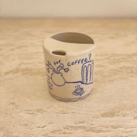 Preorders for the “meet me for coffee?” keep in mind these will take up to two months to produce and have them at your door step!  around 300-320ml  This mug is made from high-quality stoneware clay, built using the wheel, wedged, illustrated, and coated with a glossy transparent glaze. Handwashing is preferred. note: Ceramic Coffee Tumbler, Ceramic Keep Cup, Ceramic Tattoo Ideas, Ceramic To Go Mug, Ceramics Cup Ideas, Ceramic Cup Ideas, Pottery Mug Ideas, Pottery Tattoo, Pottery Tumblers