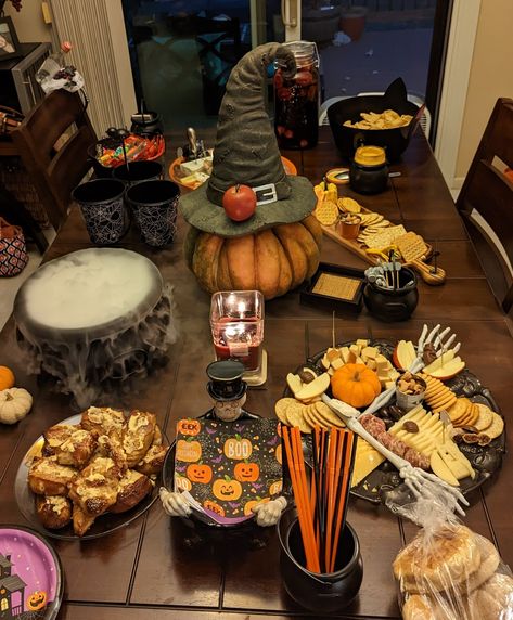 Charcuterie plate, Halloween decor, snacks, dry ice cauldron, drinks, candy cauldron, sangria Halloween Snack Table, Halloween Snack, Grazing Table, Snack Table, Grazing Tables, Halloween Snacks, Fall Vibes, Halloween Party, Table Settings