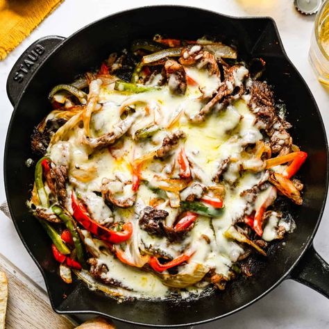 This Philly Cheesesteak Skillet is made with juicy, tender steak, onions and peppers, and melted provolone cheese. Serve on hot, crusty hoagies and dig in! All you need is 30 minutes! Philly Cheesesteak Skillet, Cheesesteak Skillet, Bang Bang Chicken, Beef Steak Recipes, Tender Steak, Philly Cheesesteak, Provolone Cheese, Philly Cheese Steak, Sheet Pan Dinners