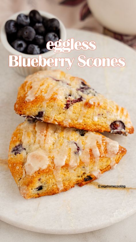 These Blueberry Scones are eggless, flaky, tender, and buttery, with each bite full of juicy blueberries. They have a bright lemon flavor and the perfect finishing touch of coarse sugar and vanilla glaze! Eggless Scones, Egg Free Baking, Lemon Scones, Eggless Desserts, Blueberry Scones, Vanilla Glaze, Eggless Cake, Lemon Flavor, Blueberry Recipes