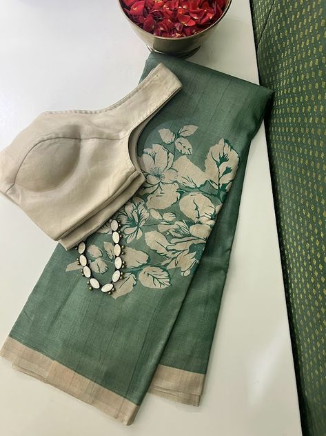 It's fascinating how a simple switch in colors can create a completely different effect. Presenting a handloom Tussar saree in Russian green with buttercup floral prints in beige along the bottom. The elegance is heightened with a beige border, blouse, and palla, evoking a charm that words fail to do describe. Paired effortlessly with our beige organza blouse and accented by a terracotta necklace, this ensemble exudes understated sophistication. Kutch Work Saree, Terracotta Necklace, Unique Sarees, Floral Sarees, Tussar Saree, Khadi Cotton Saree, Cotton Saree Blouse, Simple Saree Designs, New Saree Designs