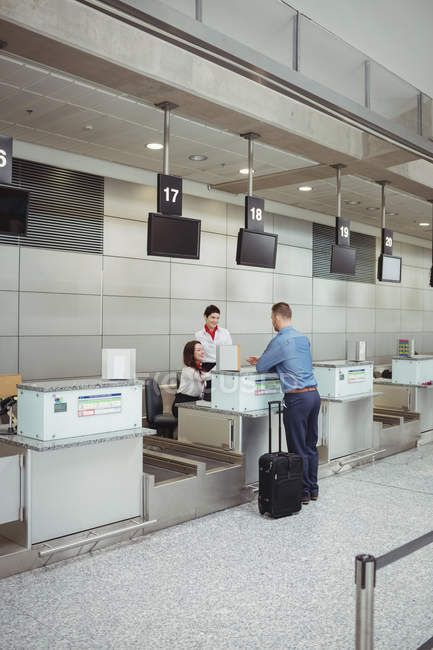 Airline check-in attendant handing passport to passenger at airport check-in counter — female, aviation - Stock Photo | #227268756 Airport Check In Counter, Bloxburg Airport, Airport Counter, Travel Etiquette, Airport Immigration, Airport Tickets, Airport Check In, Dining Room Design Luxury, City Lights At Night