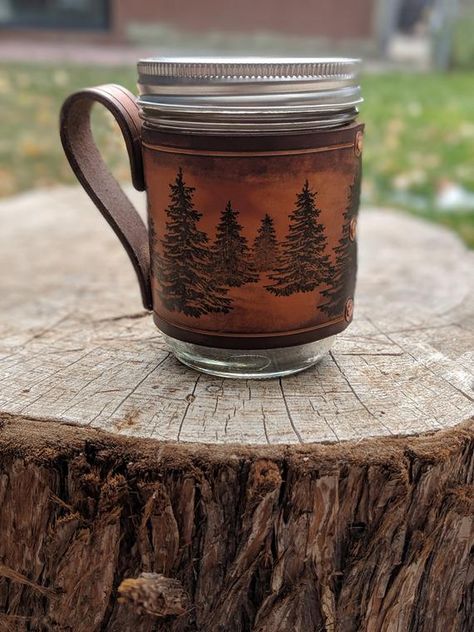 These hand-dyed, hand-printed leather sleeves will fit comfortably on a wide mouth, made in the USA, Kerr Mason jar. Each jar is 1 pint (16 oz) and measures 5H x 3 1/2 Diameter x 10 Circumference. Leather coffee mug be ordered with or without jar. Lid and ring will be included with jar purchase. Diy Leather Gifts, Leather Mason Jar, Kerr Mason Jars, Mason Jar Holder, Diy Leather Working, Leather Face Mask, Leather Money Clip Wallet, Leather Face, Leather Anniversary Gift