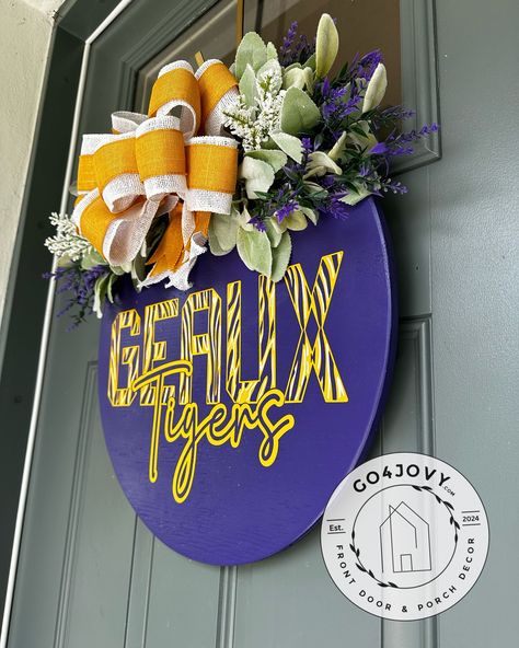 I am a KNIGHT through & through but love it when people have a passion for their hometown college. This was ordered recently pretty happy with the results. *18” Wooden Round Shown* 🐯• GEAUX Tigers! Wooden Door Hanger | LSU Door Hanger |College Spirit Front Door Decor | Housewarming Gift | Louisiana State University - Show your school spirit with our beautifully crafted wooden door hanger, perfect for supporting your LSU Tigers! A popular cheer for all LSU athletics, “Geaux Tigers,” pronou... Lsu Door Hanger, Lsu Fans, Wooden Door Hanger, College Decor, Front Door Porch, Geaux Tigers, Louisiana State University, Wooden Door Hangers, Louisiana State