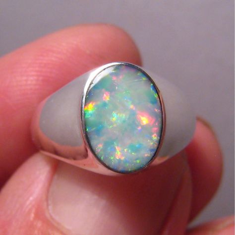 An affordable silver ring for men with an intriguing opal that displays mostly red and blue in mid range brightness.  The ring is 12 mm across north to south and weighs 5 grams. Opal Ring Men, Opal Mens Ring, Men Ornaments, Silver Ring For Men, Australian Opal Ring, Signet Ring Men, Coober Pedy, Beautiful Wedding Rings, Ring Men