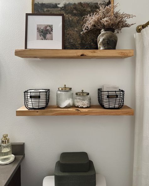 A little bathroom shelf refresh! Swapped out some storage containers, moved around some decor from other rooms, & voila-this space now feels fresh and new without spending a fortune! Comment SHOP below to receive a DM with the link to shop this post on my LTK ⬇ https://liketk.it/4OV2A . . . . #mixerofstyles #interiordesign #hometakestime #transitionaldesign #mydomaine #wearevivir #mycrumbshome #bathroomdesign #shelfie #bathroomdecor #bhghome #bhgstylemaker #interiorstyling #theeverygirlatho... Shelves About Toilet, Rustic Bathroom Shelf Decor, 2 Shelves Above Toilet, Bathroom Shelving Above Toilet, Shelf Decor In Bathroom, Bathroom Shelf Decor Over Toilet Modern, Bathroom Wall Shelf Decor, Wood Shelves Above Toilet, Toilet Shelf Decor