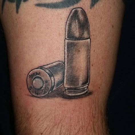 #9mm #bullet #pewpew #stillstanding #memorialdate #blackandgrey #tattoo #studio13tattoomg Point Tattoo, Bullet Tattoo, Wind Tattoo, 9mm Bullet, Shell Tattoos, Tribute Tattoos, 44 Magnum, Scale Tattoo, Hollow Point