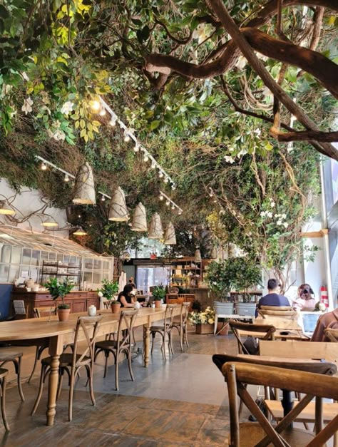 Plant Nursery Coffee Shop, Forest Bakery Aesthetic, Biophilic Cafe Design, Botanical Restaurant Interior, Garden Theme Restaurant, Fairy Cafe Aesthetic, Botanical Coffee Shop, Plant Cafe Aesthetic, Green Coffeeshop