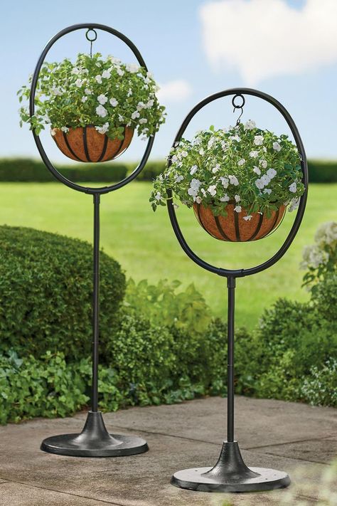 Want to display hanging planter baskets, but have no place to hang them? These freestanding, adjustable height planter displays are the solution. Boxwood Garden, Metal Sculptures Garden, Iron Planters, Cloth Store, Grandin Road, Planter Stand, Hanging Plant, Outdoor Lawn, Room With Plants