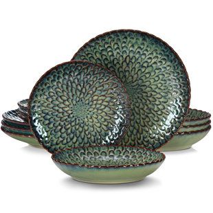 The Elama jade waves 16-piece dinnerware set in green brings a truly stunning accent to your tableware with its unique pattern and texture. The high gloss finish of this luxurious set will tantalize your sense of touch while the bold colors will entice your sense of sight. A textured pattern rim adorning the edges of the dinner and salad plates enhances the luxurious feel of these dinnerware pieces. The same rim runs along the top edge of the mugs to add a special touch complimenting the rest of Crockery Set, Plates And Bowls Set, Green Plates, Restaurant Decoration, Ceramic Dinnerware Set, Stoneware Dinnerware Sets, Solid Shapes, Stoneware Dinnerware, Reactive Glaze