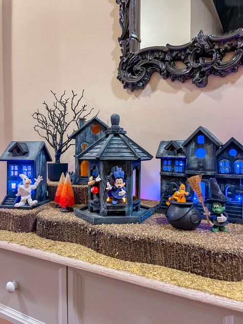 I’m not sure if you’ve seen the Disney Halloween Village from Costco that has gone viral on social media. I have looked high and low for the Disney Village at our local Costco, but I haven’t had any success. I... Read More The post How to Make Your Own Halloween Village first appeared on Helen G. Bailey. The post How to Make Your Own Halloween Village appeared first on Helen G. Bailey. Disney Halloween Village Display, Halloween Village Display Ideas Diy, Disney Halloween Village, Fall Village Display, Diy Disney Halloween Decor, Diy Halloween Village Houses, Halloween Village Display Ideas, Halloween Village Diy, Halloween Fairies