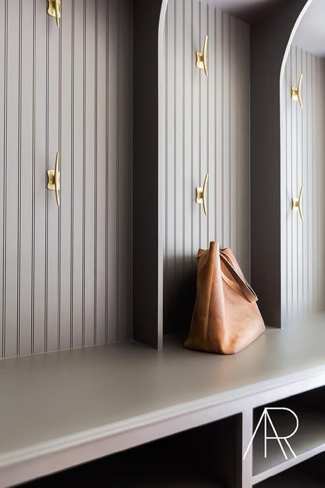 Not sure but the hooks look like boat tie-downs to me.  Very Nautical Touch - Julie Couch Interiors -Stunning mudroom features gray beadboard lockers lined with brass hooks over a mudroom+bench+fitted+with+stacked+open+cubbies+used+as+shoe+shelves. Gray Beadboard, Transitional Laundry Room, Laundry Room/mud Room, Mudroom Lockers, Mudroom Laundry Room, Diy Entryway, Mudroom Design, Boot Room, Laundry Mud Room