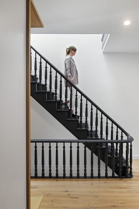 The well-preserved staircase railing and spindles are now painted matte black. #blackstaircase #townhouseremodel #renovation Painted Staircase Railing, Edwardian Staircase, Painted Stair Railings, Black Stair Railing, Staircase Spindles, Black Staircase, Stair Spindles, Painted Staircases, Black Stairs