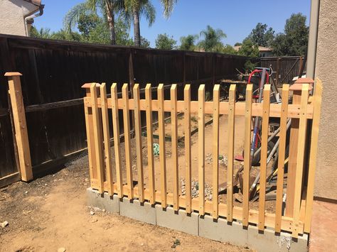 Build a fence using cinder blocks as the base. All the wood was purchased and cut to fit using a saw. Posts cemented into the cinder block. Wood is being stained and cinder blocks painted to match the patio color. Backyard Sandbox, Build A Fence, Cinder Block Walls, Colorful Patio, Cinder Blocks, Cement Blocks, Pallet Fence, Patio Fence, Diy Fence