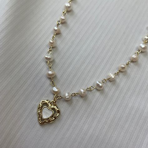 Aesthetic, soft-grunge, princessy pearl necklace made with real freshwater pearls, 18K gold-plated stainless steel and sterling silver 925. - Natural freshwater pearls - 18k Gold Plated sterling silver - Stainless Steel - Durable and hypo-allergic Jewellery 💎high quality, only precious materials 💘every jewelry piece is unique, handmade, one of a kind ✈️shipping worldwide (just press buy!) 💌beautiful packaging <3 Every order comes with free beautiful stickers matching the vibe of the necklace Length: 35-45 (13.7-18in) Gift option - Comes packaged beautifully in a gift bag, ready to be gifted to your loved one or as a treat for yourself Feel free to ask any questions🤍 🖤Shipping WORLDWIDE | FREE international shipping with orders of more than 1 item 🖤Feel free to ask any questions. I re Coquette Gold Jewellery, Pearl Necklace With Pendant, Aesthetic Pearl Necklace, Pearl And Gold Jewelry, Cottage Jewelry, Girly Cottage, Heart Gold Necklace, Gold And Pearl Necklace, Cottage Core Jewelry