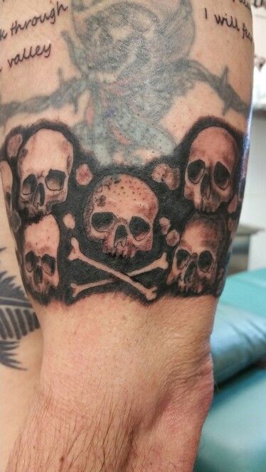 Skull Band Tattoo, Skull Arm Band Tattoo, Skull Filler Tattoo Ideas, Catacombs Tattoo, Skull Bracelet Tattoo, Stacked Skulls Tattoo, Skull Tattoo Inner Bicep, Upper Arm Skull Tattoo, Masculine Skull Tattoo