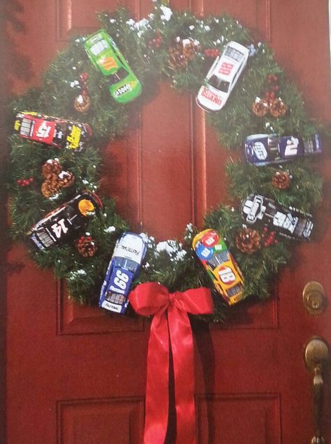 Nascar wreath. I would definitely switch up the cars. We need a Denny Hamlin on there. Nascar Wreath Ideas, Race Car Wreath, Car Wreath Christmas, Nascar Christmas Tree, Nascar Crafts, Car Wreath, F1 Christmas, Nascar Party, Sports Wreaths