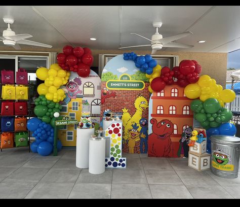 Sesame Street birthday backdrop. Foam walls, balloon garlands, cylinders for desserts and aesthetics. Affiliate link for affordable cake stand cylinders. #sesamestreetparty #sesamestreet #elmobirthdayparty #elmo #birthdaydecoration #sesamestreetcenterpiece #1stbirthday #cylindercakestand #cakestand #cakes #backdrop Elmo Backdrop, Elmo Balloon Garland, Sesame Street Balloon Arch, Diy Sesame Street Decorations, Sesame Street Birthday Party Ideas 1st, Sesame Street Party Decorations, Sesame Street Backdrop, Pedestal Decor, Elmo Party Decorations