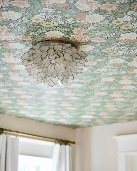 This floral wallpaper was added to the ceiling for a major wow moment in this Wallingford home. The wallpaper set the stage for the entire room, allowing us to easily decorate and furnish the bedroom. We recommend wallpapering ceilings in guest bedrooms and kids bedrooms, because it's an easy way to update a room without having to commit to a print for your primary bedroom. #ThePhinery #PhineryStyle #FindItStyleIT #SMMakeLifeBeatufiul #SODomino #CurrentDesignSituation #ApartmentTherapy #MyDom... Wallpaper On Ceiling Girls Room, Floral Wallpaper On Ceiling, Nursery Ceiling Wallpaper, Wallpaper On Bedroom Ceiling, Wallpaper Ceiling Kitchen, Girls Bedroom Ideas Wallpaper, Wallpapering Ceilings, Wallpaper In Ceiling, Floral Wallpaper Ceiling