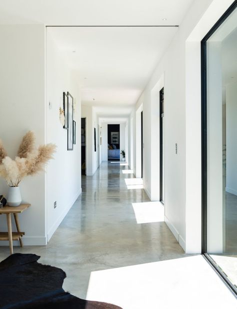 How concrete, metal and timber is warm and welcoming in this chic home Styling Concrete Floors, White Concrete Flooring, Cozy Concrete Floors, Light Colored Concrete Floors, Concrete Floors Modern Home, Raw Concrete Floors, Light Polished Concrete Floor, Polished Concrete Floor Interior Design, Cream Concrete Floors