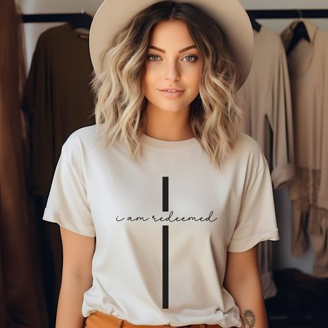 This I am Redeemed Shirt is a great gift for any Jesus loving Christian Woman, or pick one up for yourself.  ❤️Love the design and want it in a sweatshirt? We got you covered. Tap here: SHORT SLEEVE TSHIRT FIT: ⚡️Tapered shoulder so it retains its shape even after washing. ⚡️crew neckline adds a timeless, classic touch and a neat appearance that is perfect for showcasing accessories like necklaces or scarves.  COMFORT / QUALITY / MATERIAL ⚡️Soft cotton & quality print ⚡️Polyester and cotton. (this combo lends to the highest quality print on a sweatshirt) ⚡️There are no itchy side seams on these sweaters. ⚡️The 100% Airlume combed and ring-spun cotton feels soft to the touch. ⚡️This t-shirt comes with a lightweight fabric (4.2 oz/yd² (142 g/m ⚡️Bella+Canvas brand  ⚡️made in the USA!  ⚡️ The Tee Shirt Designs Ideas, T Shirt Outfits Women, I Am Redeemed, Church Shirt Designs, Christian Shirts For Women, Christian Tee Shirts, Christian Tshirt Design, Jesus Clothes, Christian Shirts Designs