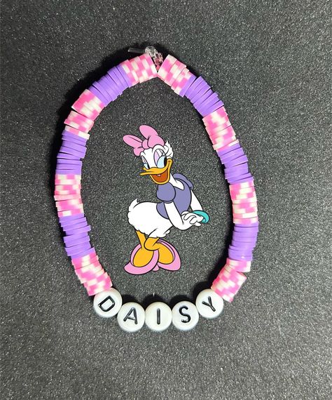 Daisy Duck (Mickey Mouse Clubhouse) Heishi Bracelet #handmadebracelet #heishibracelets #beadedbracelets #bracelets #personalizedbracelets #personalizedbracelet #mickeymouseclubhouse #mickeymousefriends #disneyprincess #daisyduckbracelet #disneyprincessbracelet #daisyduck Disney Beaded Bracelet Diy, Disney Friendship Bracelet Ideas, Disney Bead Bracelet, Disney Clay Bead Bracelets Ideas, Disney Bracelet Ideas, Disney Princess Bracelet, Cute Clay Bead Bracelet Ideas, Disney Bracelets, Cartoon Bracelet