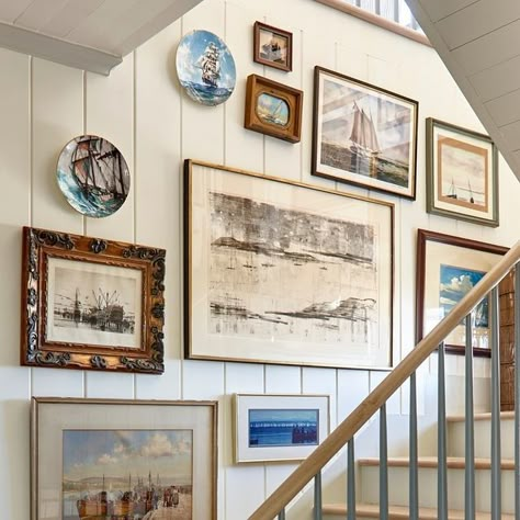 FRAN KEENAN DESIGN on Instagram: "It's no secret... we LOVE a good gallery wall around here! This one is from our Blue View project in lovely 30A. We opted to adorn every wall of the stairway in collected, nautical themed pieces for a cohesive look with big impact. 🌊 ⁠" Blue Themed Wall Art, Beach Gallery Wall Ideas, Coastal Gallery Wall Bedroom, Beachy Gallery Wall, Gallery Wall On Navy Blue Wall, Nautical Hallway, Beach Art Gallery Wall, Beach Theme Gallery Wall, Vintage Coastal Gallery Wall