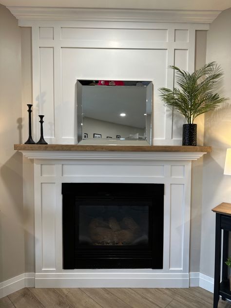 White shaker fireplace with natural wood stained mantle White Mantle With Wood Top, Wood And White Fireplace, Shaker Style Fireplace Surround, Wood Mantle Slipcover, White Wood Mantle Fireplace, White Fireplace Surround Wood Mantle, Shaker Fireplace Mantel, White Trim Fireplace, Wood Mantle Surround