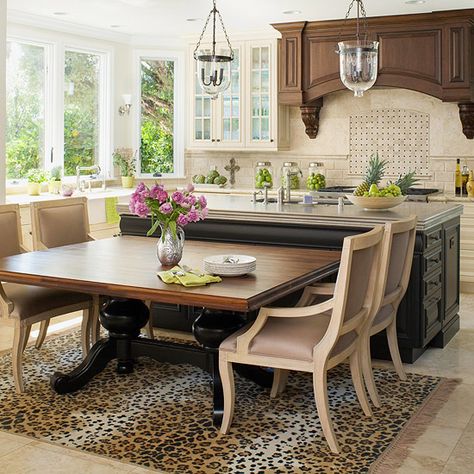 Elegant Countertop~        A stunning pewter-topped island is the centerpiece of this French-inspired kitchen. The decorative edge on the countertop adds an unexpected twist to the black base. To add seating, the homeowner pushed a custom walnut table against the island. The elegant table adds dining room formality to this in-kitchen eating area. Kitchen Island Dining Table Combo, Kitchen Eating Areas, Kitchen Island Dining Table, Dining Room Windows, Seating Ideas, Kitchen Island Table, Farmhouse Kitchen Island, Kitchen Island With Seating, Diy Kitchen Island