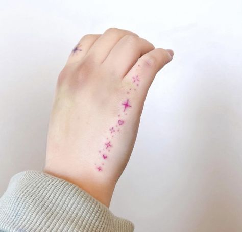 Butterflies With Sparkles Tattoo, Pink Girly Tattoos, Pink Sparkle Tattoo, Kawaii Hand Tattoo, Small Pink Tattoo, Pink Hand Tattoo, Hand Tattoos Sparkles, Sparkle Finger Tattoo, Dainty Girly Tattoos