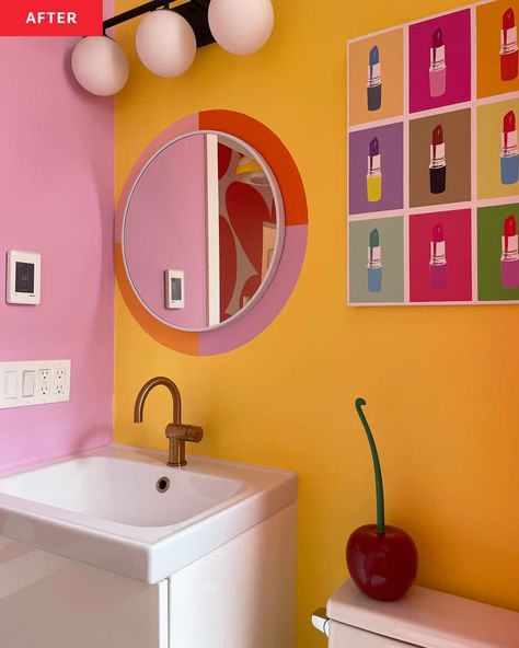 Bathroom after renovation: yellow and pink walls, colorful pop art style lipstick poster, round mirror with orange, lavender paint around it Paint Around Mirror, Colorful Bathroom Walls, Yellow And Pink Bathroom Ideas, Mirror With Paintings Around It, Pop Art Bathroom Ideas, Retro Bathroom Mirror, Pink Yellow Bathroom, Yellow And Pink Bathroom, Orange And Yellow Bathroom