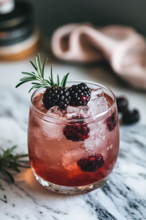 A photo of a  Yuletide Bramble a Christmas Gin Cocktails Bramble Gin Cocktail, Yule Cocktails, Pink Christmas Cocktail, Christmas Batch Cocktails, Winter Gin Cocktails, Gin Bramble, Christmas Gin Cocktails, Cocktail With Gin, Winter Cocktail Party