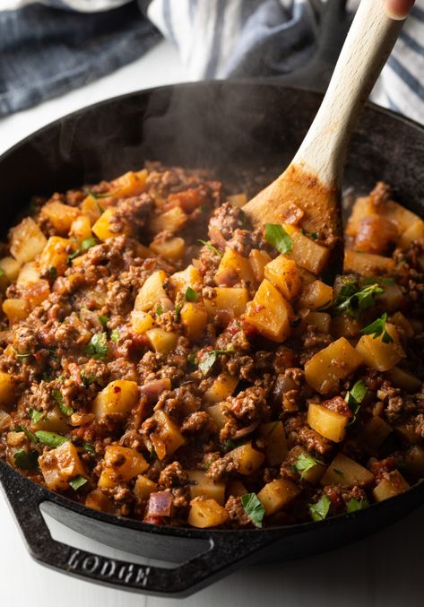 Wooden spoon stirring in the chopped parsley. Ground Sausage Potato Recipes, Ground Beef Potato Carrot Recipe, Ground Beef Stuffed Potatoes, Ground Beef Potatoes Skillet, Ground Sausage And Potatoes, Potato Ground Beef Recipes, Potatoes And Ground Beef Recipes, Italian Ground Beef Recipes, Ground Beef And Sausage Recipes