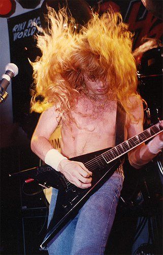 Dave Mustaine, Megadeth, Gibson Flying V.  No tattoos because "you don't put a bumper sticker on Mercedes-Benz."  Mustaine was original lead guitarist for Metallica. No Tattoos, Vic Rattlehead, David Ellefson, Gibson Flying V, Jackson Guitars, Rock Guitarist, Dave Mustaine, Flying V, Facial Expression