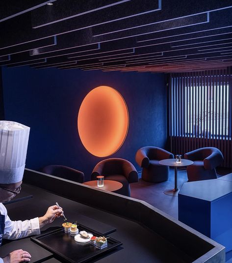 This two Michelin-star restaurant in Italy features a bar lounge immersed in blue and neon orange light - Yanko Design Restaurant In Italy, Udine Italy, Geometric Volume, Italian Bar, Blue Lounge, Internal Courtyard, Futuristic Interior, Architecture Magazines, Orange Light