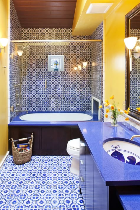 A Moroccan-inspired bathroom by Susan E. Brown Interior Design boasts vibrant blue shower tiles and yellow painted walls. #morocco #moroccanbathroom #tiledbathroom Royal Blue Bathrooms, Moroccan Inspired Bathroom, Green Shower Tile, Blue Shower Tile, Mediterranean Bathroom, Yellow Bathroom Decor, Blue Bathroom Tile, Brown Bathroom Decor, Blue Bathroom Decor