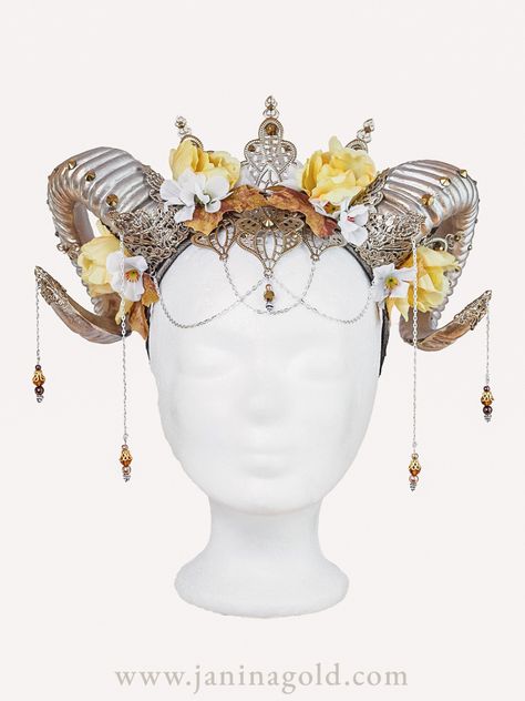 Elevate your style with this stunning floral headdress featuring intricate details of pearls and silver plating. The delicate flowers in light yellow and bronze hues add a touch of elegance and sophistication to the piece, while the horns create a bold and unique statement. Perfect for weddings, festivals, or any special occasion, this headdress is sure to turn heads and make a lasting impression. Horns With Jewelry, Fantasy Headdresses, Pirate Comic, Fantasy Ball, Dragon Horns, Fantasy Crown, Floral Headdress, Horn Jewelry, Delicate Flowers