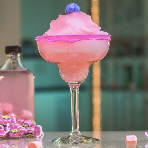 The Bubble Gum Colada is a gorgeous pink cocktail for all you tipsy princesses out there. This stunningly sweet take on the classic piña colada calls for a bag of bubble gum, a bottle of rum, and cream of coconut. Rim the glass with pink frosting and garnish with a lollipop for even more pink prettiness. Best Party Drinks, Party Alcohol Drinks, Jungle Juice Recipe, Cocktails Vodka, Cocktail Pink, Candy Cocktails, Strawberry Mojito, Tipsy Bartender, Jungle Juice